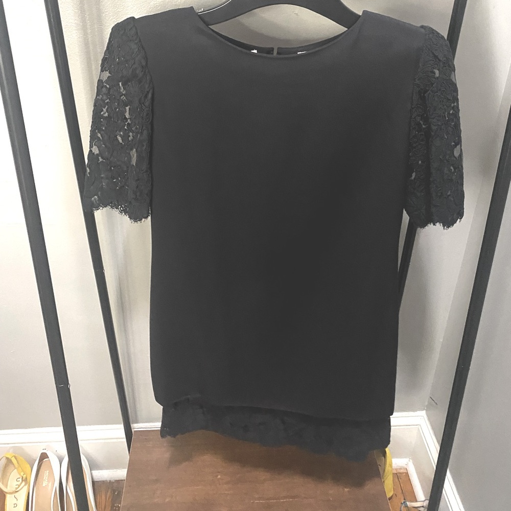 Helga black dress with lace at sleeves and hem of the bottom and shoulder pads